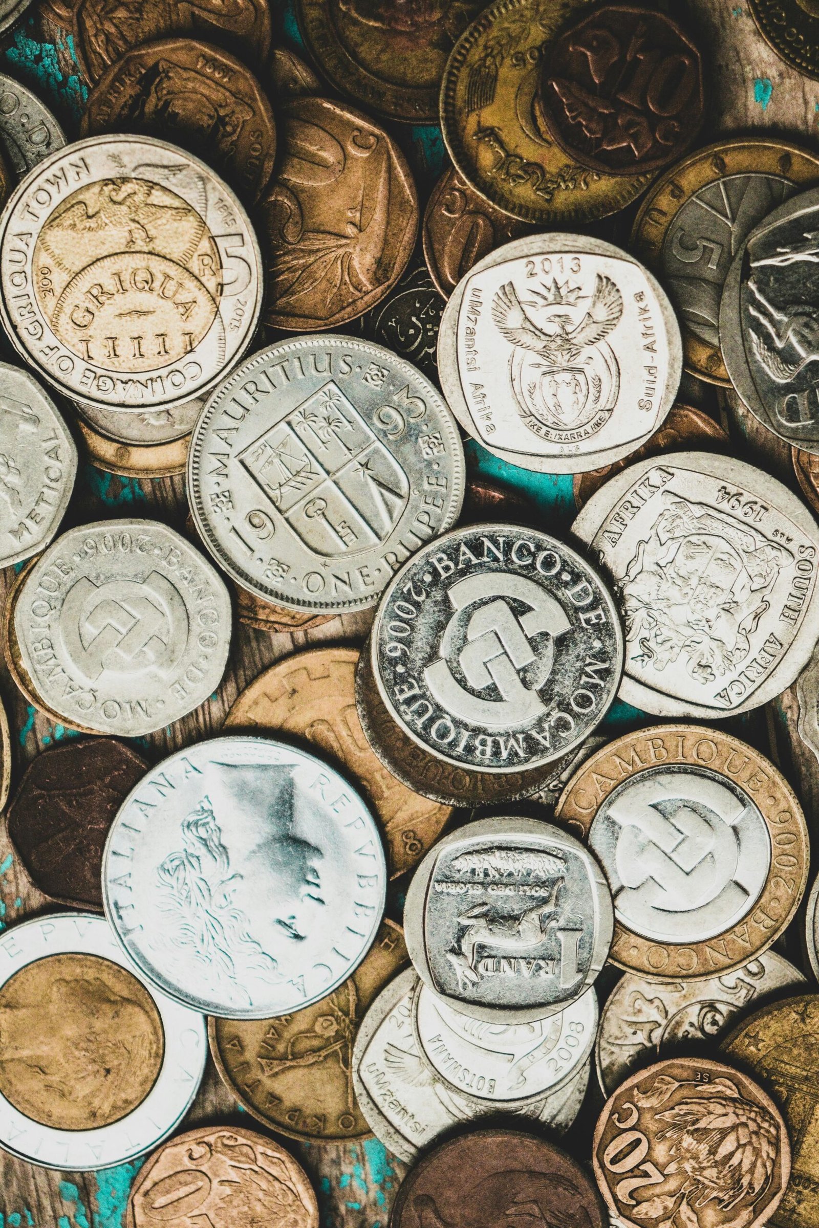 A detailed close-up of a collection of international coins showcasing various currencies.